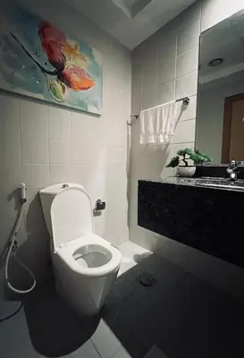 a bathroom with a white toilet and a sink at Modern 1BR Unit with Canal View Near Burj Khalifa in Dubai