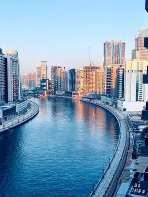 a river in the middle of a city with buildings at Modern 1BR Unit with Canal View Near Burj Khalifa in Dubai