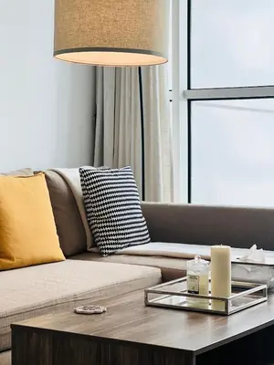 a living room with a couch and a table with a lamp at Modern 1BR Unit with Canal View Near Burj Khalifa in Dubai