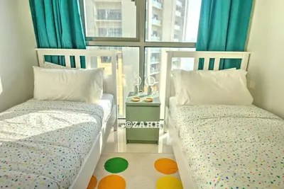 two beds in a small room with a window at Business bay Chic Apartment in Dubai