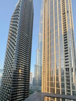 two tall skyscrapers in a city with buildings at Burj Khalifa View Apartment 10 min Walking to Dubai Mall in Dubai