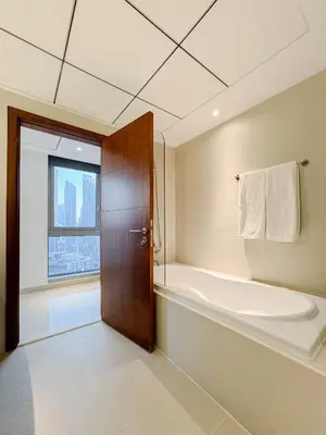 a bathroom with a bath tub and a large window at Burj Khalifa View Apartment 10 min Walking to Dubai Mall in Dubai