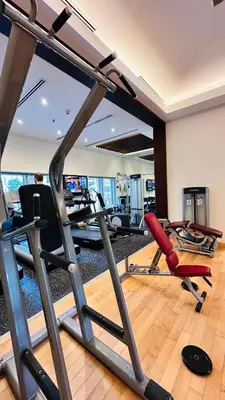 a gym with several exercise equipment in a room at Burj Khalifa View Apartment 10 min Walking to Dubai Mall in Dubai