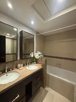 a bathroom with two sinks and a bath tub at Luxury One Bedroom Apartment with Fountain View opposite Dubai Mall in Dubai