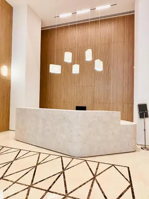 a reception desk in a lobby with wood at Luxury One Bedroom Apartment with Fountain View opposite Dubai Mall in Dubai