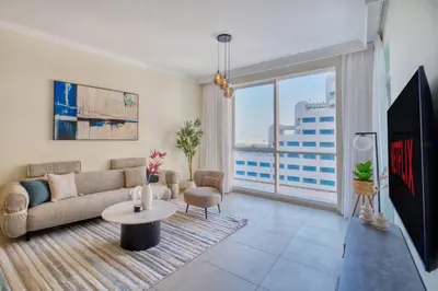 a living room with a couch and a table at Beachy Getaway in JBR with Private Beach Access in Dubai