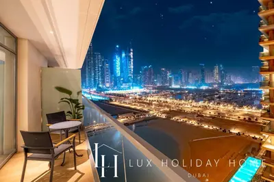 a room with a view of a city at night at LUX The Marina Vista Beachfront Suite 4 in Dubai