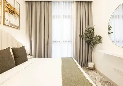 a white bedroom with a large bed and a window at Stylish Downtown Retreat, Burj Crown, Opera & Boulevard View in Dubai