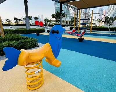 a playground with a toy dolphin and a slide at Stylish Downtown Retreat, Burj Crown, Opera & Boulevard View in Dubai