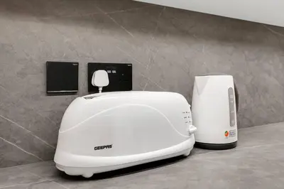 a white toaster sitting on top of a counter at FIRST CLASS 1BR Breathtaking Downtown View in Dubai