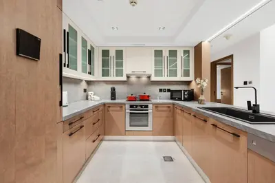 a kitchen with wooden cabinets and a sink at FIRST CLASS 1BR Breathtaking Downtown View in Dubai