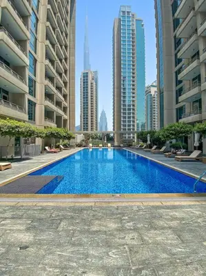 a large swimming pool in a city with tall buildings at FIRST CLASS 1BR Breathtaking Downtown View in Dubai