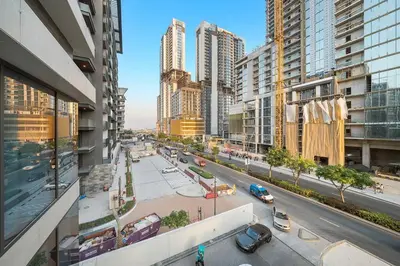 a view of a city street with cars and buildings at FIRST CLASS 3BR Lively Sanctuary in Dubai