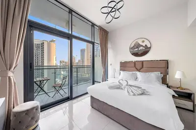 a bedroom with a bed and a large window at 1BR Dubai, Merano Canal View Retreat Near Metro Dining Shopping Mall in Dubai