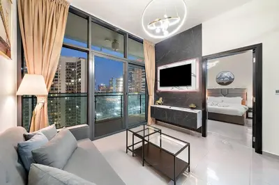 a living room with a couch and a large window at 1BR Dubai, Merano Canal View Retreat Near Metro Dining Shopping Mall in Dubai