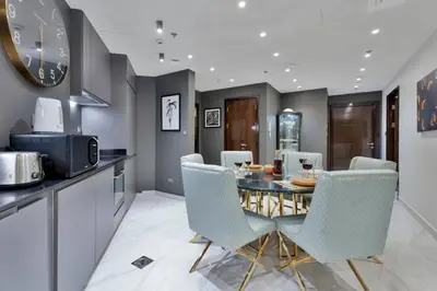 a kitchen and dining room with a table and chairs at Luxury 2BRin Torch Tower with Dubai Marina Skyline Views in Dubai