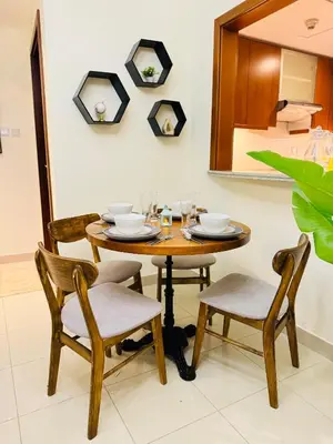 a dining room table with two chairs and a mirror at 1 BHK Apartment in Dubai in front of Burj Khalifa in Dubai