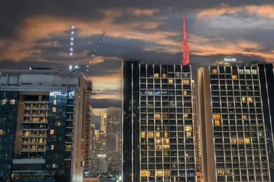 a group of tall buildings in a city at night at FIRST CLASS 2BR Luxury Urban Escape in Dubai