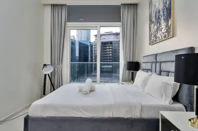 a bedroom with a white teddy bear sitting on a bed at FIRST CLASS 2BR Luxury Urban Escape in Dubai
