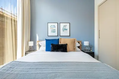a bedroom with a large bed with blue walls at GuestReady - Family retreat at Sobha Creek Vista in Dubai