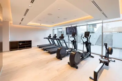a gym with treadmills and elliptical machines at GuestReady - Family retreat at Sobha Creek Vista in Dubai
