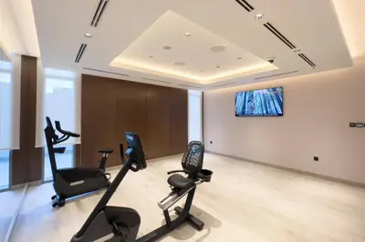 a gym with cardio equipment in a room at GuestReady - Family retreat at Sobha Creek Vista in Dubai