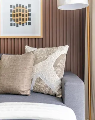 a bed with a pillow and a lamp on it at GuestReady - Family retreat at Sobha Creek Vista in Dubai