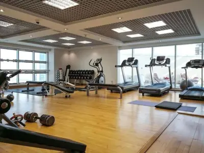 a gym with several treadmills and machines in a room at Stunning Apartment - High Floor - Canal View in Dubai