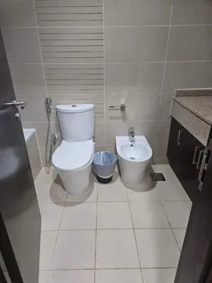 a bathroom with a toilet and a sink at Stunning Apartment - High Floor - Canal View in Dubai