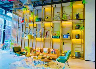 a living room with a couch and tables and chairs at Dubai Hills estate - 1Bedroom Apt in Dubai