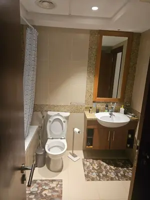 a bathroom with a toilet and a sink at Fairways north in Dubai