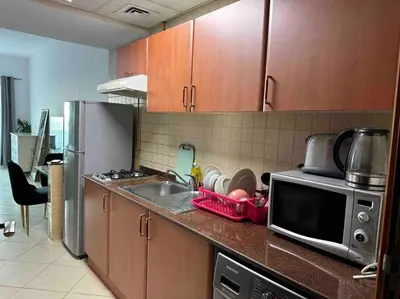 a kitchen with a sink and a microwave at Beautiful Studio Apartment in Dubai