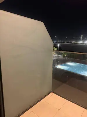 a view of a swimming pool on a balcony at night at The Perfect Couples Nest in Dubai
