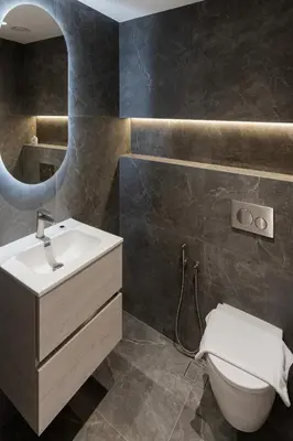a bathroom with a sink and a toilet and a mirror at Al Andalus Tower F, Cadiz JGE - 3BR Apartment - Allsopp & Allsopp in Dubai