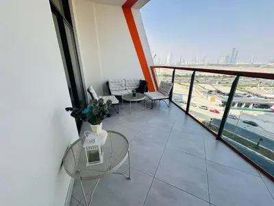 a balcony with a table and chairs in a building at Comfy 1br In Al Jaddaf Balcony Parking in Dubai