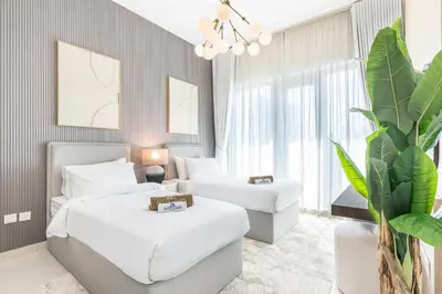a hotel room with two beds and a couch at Nicely Furnished Home in the Heart of Business Bay in Dubai