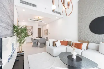 a living room with a white couch and a table at Nicely Furnished Home in the Heart of Business Bay in Dubai