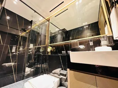 a bathroom with a toilet and a sink and a mirror at Sleek 1br In Jvc Free Parking Pool & Balcony in Dubai