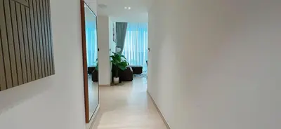 a hallway with a mirror on the wall at Sleek 1br In Jvc Free Parking Pool & Balcony in Dubai