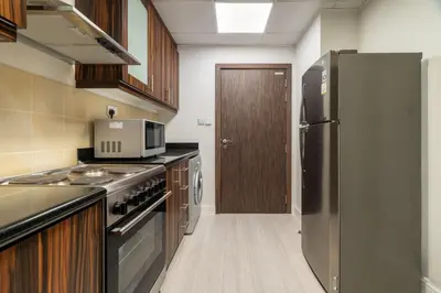 a kitchen with stainless steel appliances and a refrigerator at GuestReady - Contemporary stay in Dubai Marina in Dubai