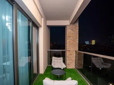 a balcony with two chairs and a table on a building at Elgant 2 bedroom in Dubai