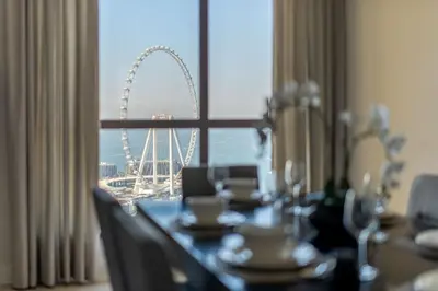 a dining table with a view of the london eye at GuestReady - Charming retreat in Dubai Marina in Dubai