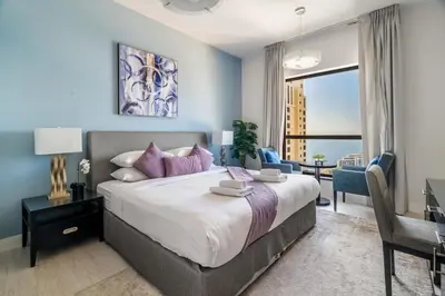 a bedroom with a large bed with a view of the ocean at GuestReady - Charming retreat in Dubai Marina in Dubai
