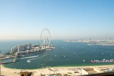 a ferris wheel in the water next to a beach at GuestReady - Charming retreat in Dubai Marina in Dubai