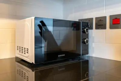 a microwave oven sitting on top of a table at Lux BnB I 29 Blvd I Burj Khalifa & Fountain Views in Dubai