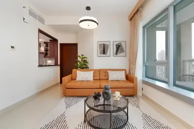 a living room with a couch and a table at Lux BnB I 29 Blvd I Burj Khalifa & Fountain Views in Dubai