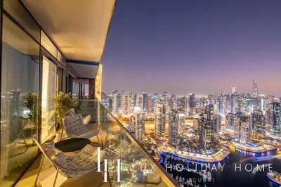 a room with a view of a city at night at LUX The Marina Gate Sea View Suite 2 in Dubai