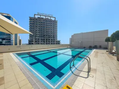 a large swimming pool on top of a building at Spacious 1-Bedroom Apartment In Bay Square in Dubai