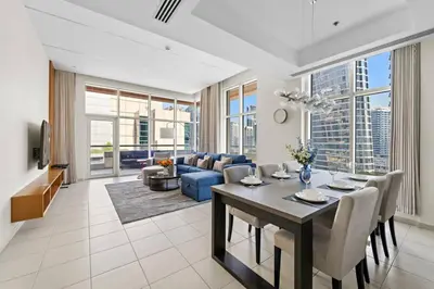 a living room with a couch and a table at Spacious 1-Bedroom Apartment In Bay Square in Dubai
