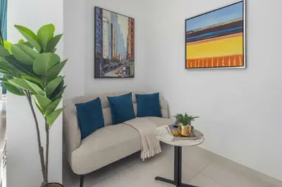 a living room with a couch and a table at Frank Porter - Damac Cour Jardin in Dubai